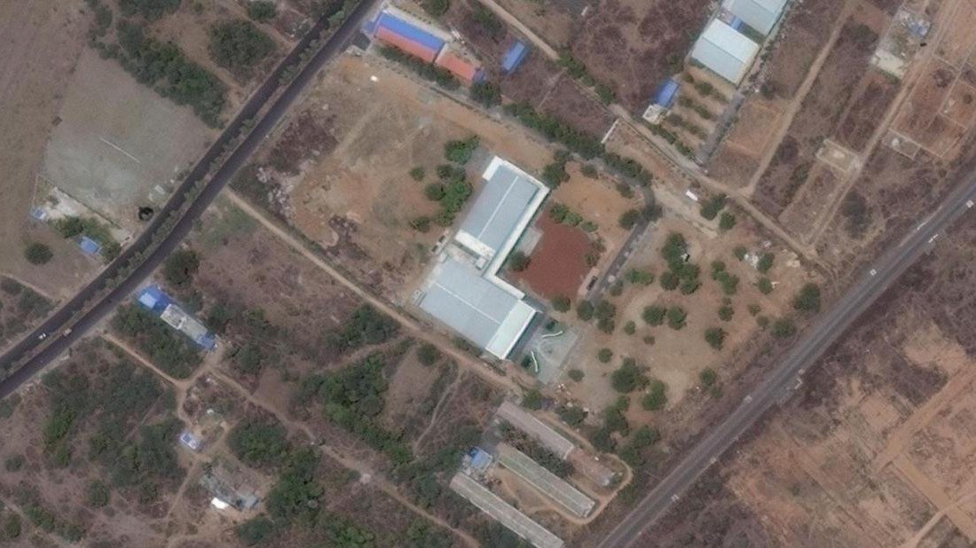 Satellite view of the property: the hall block and its paved forecourt, with a road along each side of the site.